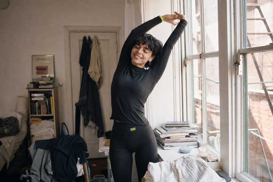 Stretching by the window in the HOLD long-sleeve
